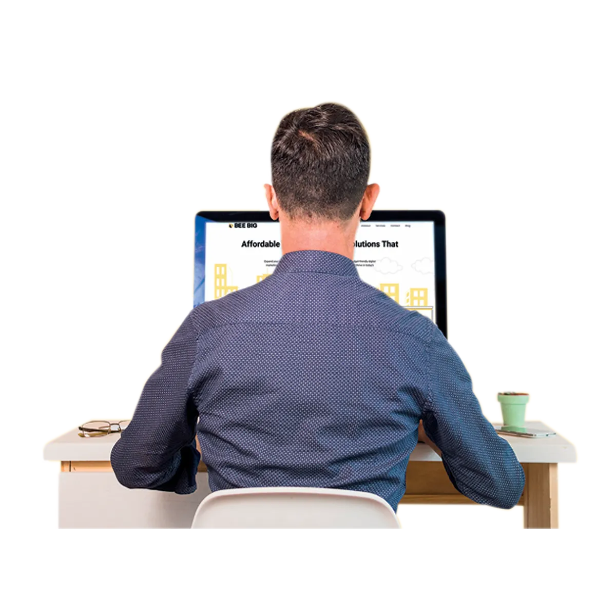 Professional working on web development at his desk, focused on a computer screen. Represents coding, programming, and remote work.